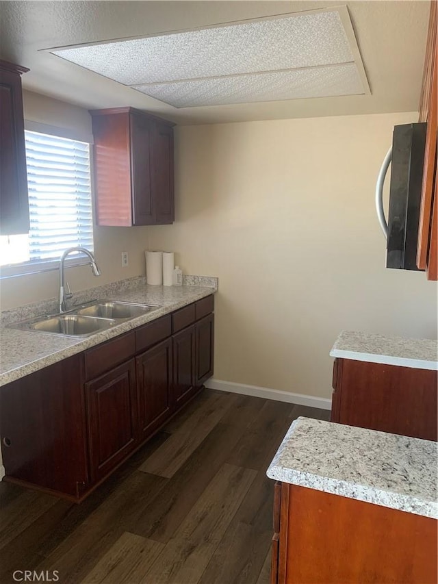 21834 Belshire Ave Unit 2, Hawaiian Gardens, CA 90716 - kitchen with baseboards, dark wood finished floors, a sink, light countertops, and a textured ceiling