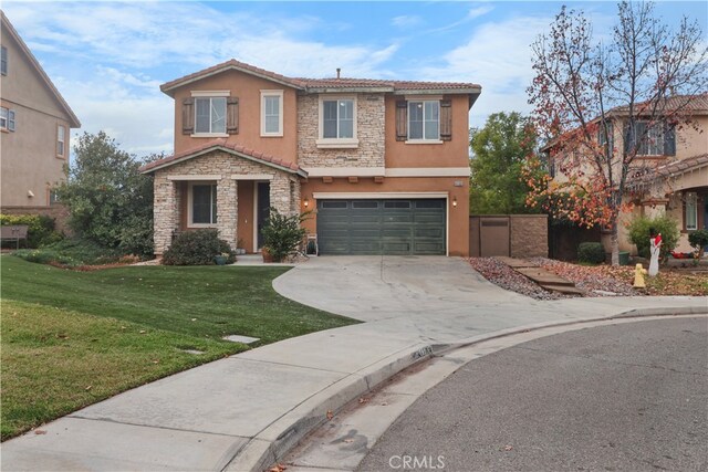 view of front of home with a front lawn and a garage