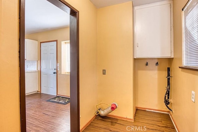 clothes washing area featuring cabinets and light wood-type flooring