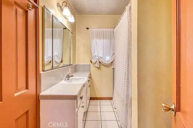 bathroom featuring tile patterned flooring and vanity