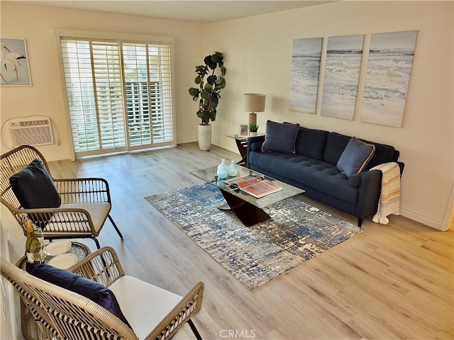 living room with hardwood / wood-style flooring and an AC wall unit