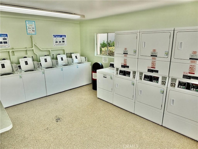 clothes washing area with stacked washer / drying machine and washer and clothes dryer