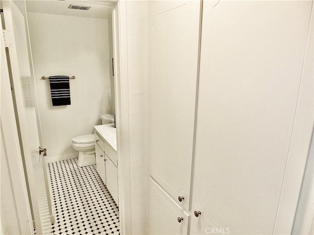 bathroom with toilet and vanity