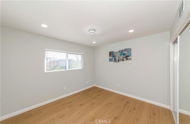 empty room with hardwood / wood-style floors