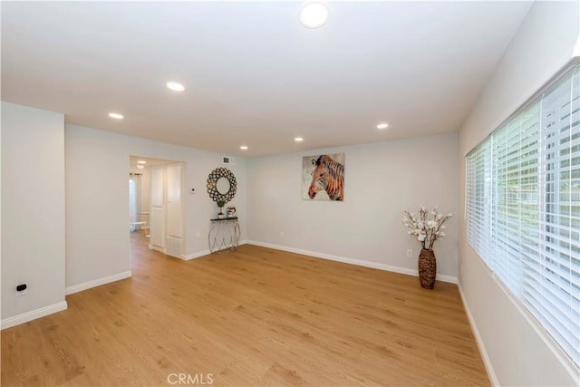 empty room with light hardwood / wood-style floors