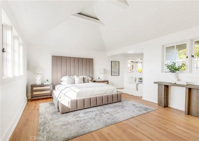 bedroom with high vaulted ceiling, hardwood / wood-style floors, and beam ceiling