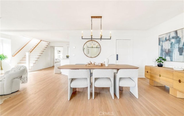 dining room featuring light hardwood / wood-style flooring and an inviting chandelier