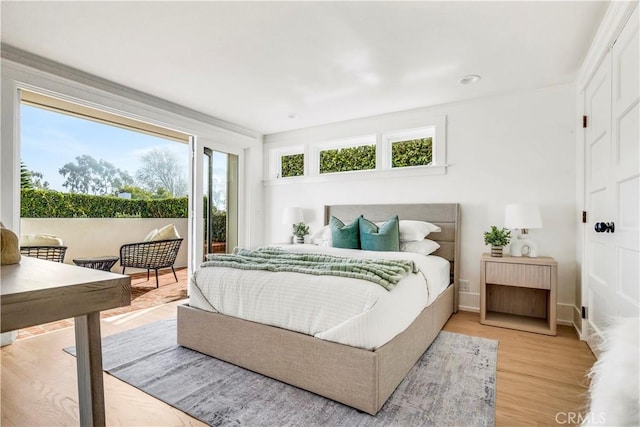 bedroom with light wood-type flooring and multiple windows