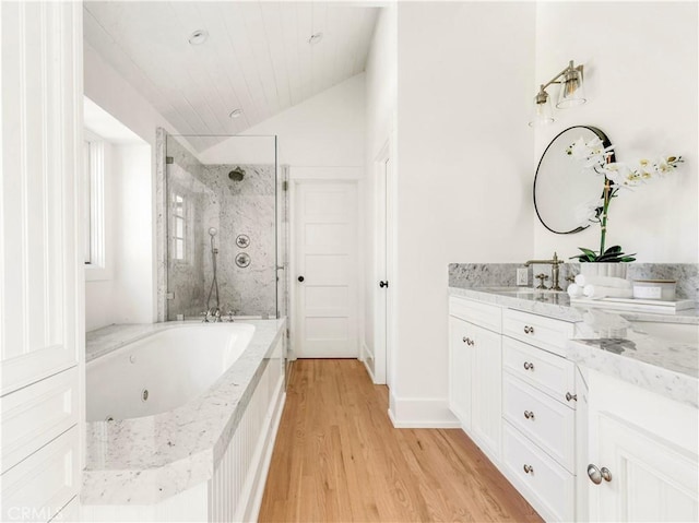 bathroom with separate shower and tub, vanity, wood-type flooring, and lofted ceiling