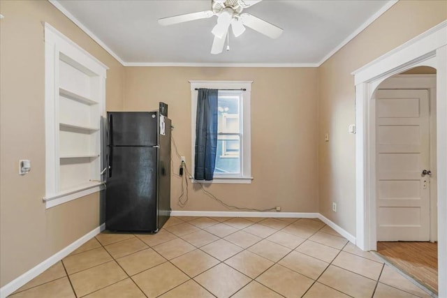 kitchen with black refrigerator, ceiling fan, crown molding, and light tile patterned floors