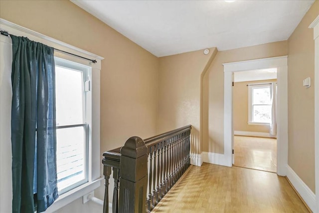 corridor with light hardwood / wood-style flooring