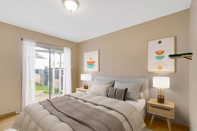 bedroom featuring access to exterior and light hardwood / wood-style floors