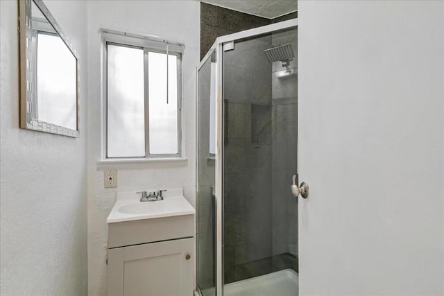 bathroom with vanity and a shower with shower door