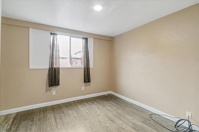 unfurnished room with hardwood / wood-style flooring