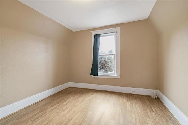 bonus room featuring vaulted ceiling and light wood-type flooring