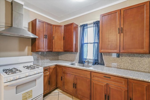 kitchen featuring sink, white range with gas stovetop, light tile patterned floors, light stone countertops, and wall chimney range hood