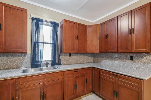 kitchen featuring tasteful backsplash, sink, and light tile patterned floors