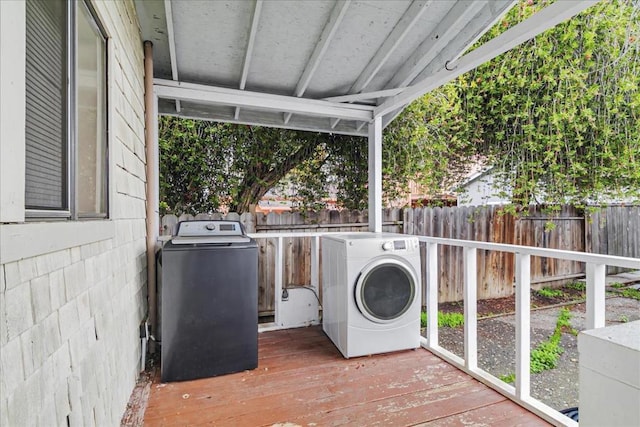 laundry area with hardwood / wood-style flooring and washer and clothes dryer