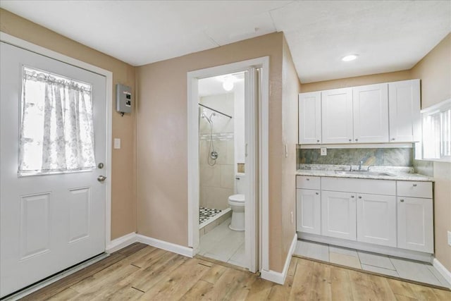 doorway featuring plenty of natural light, sink, and light wood-type flooring