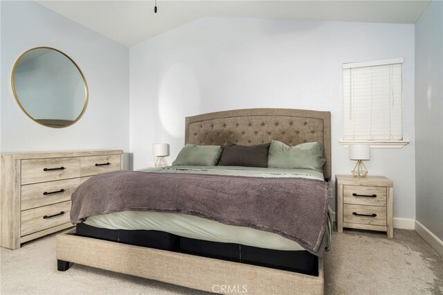 carpeted bedroom featuring lofted ceiling