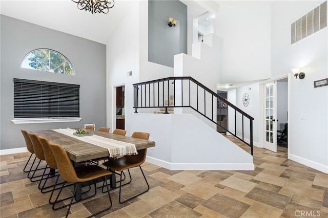 dining room featuring an inviting chandelier and a high ceiling