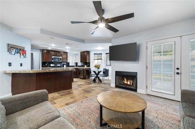 living room featuring ceiling fan, french doors, and a wealth of natural light