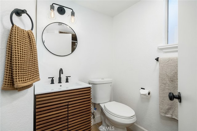 bathroom featuring toilet and vanity