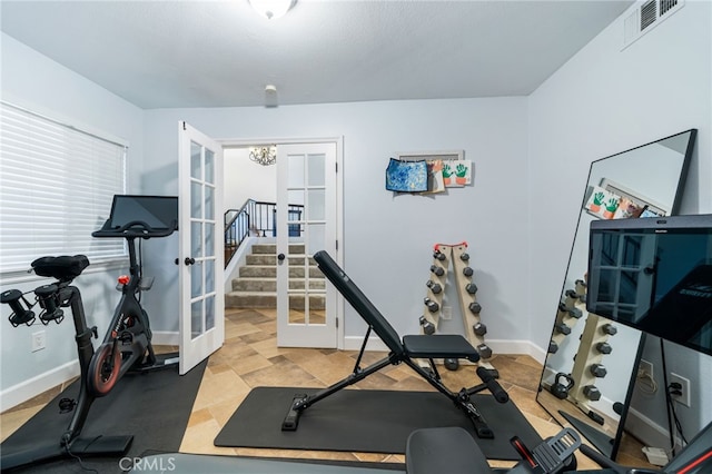 exercise area with a notable chandelier and french doors