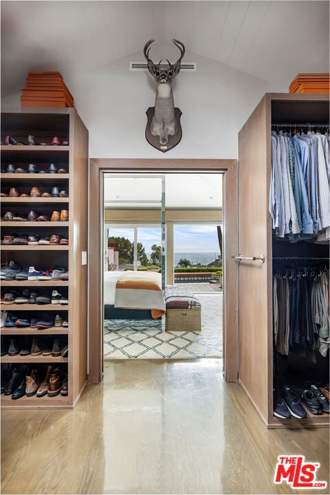 interior space featuring lofted ceiling and light wood-type flooring