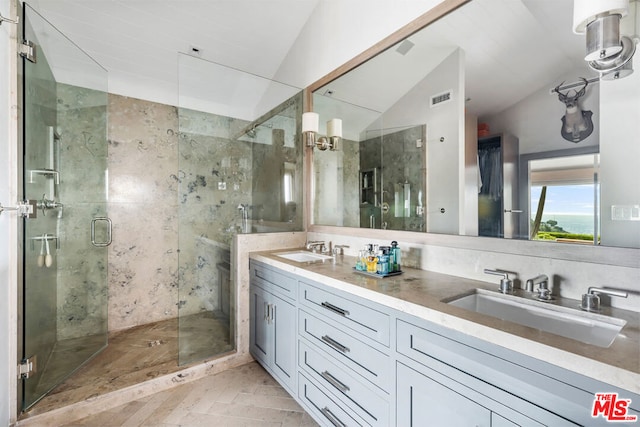 bathroom with vaulted ceiling, an enclosed shower, and vanity