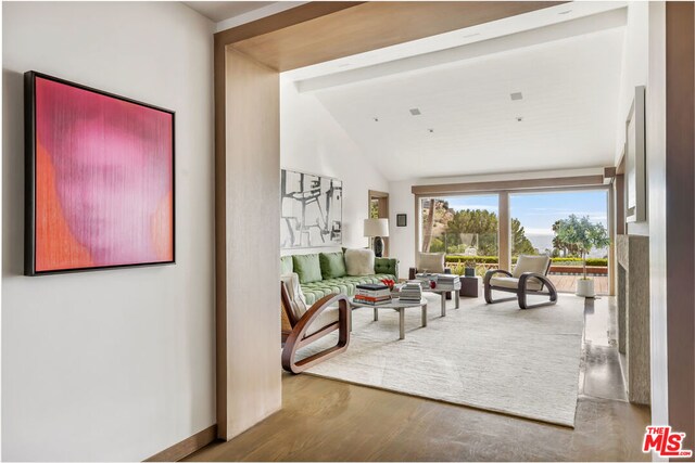 living room with hardwood / wood-style flooring, high vaulted ceiling, and beamed ceiling