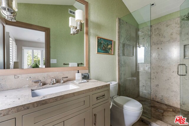 bathroom featuring lofted ceiling, vanity, toilet, and walk in shower