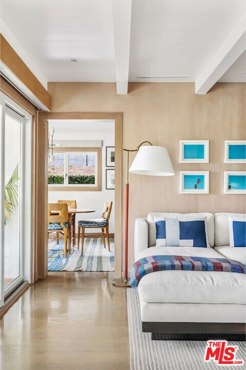 bedroom featuring hardwood / wood-style floors, access to outside, and beamed ceiling