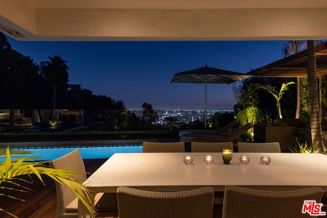 view of pool at twilight