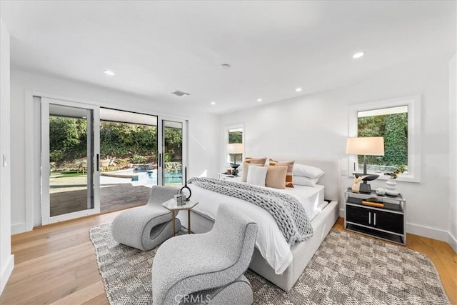 bedroom featuring light wood-type flooring and access to outside