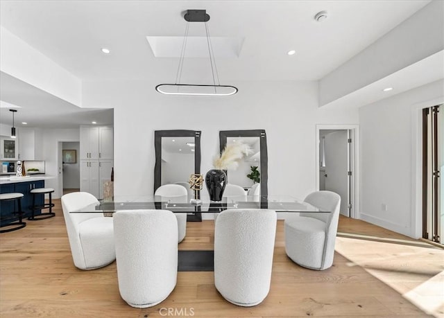 dining space with light hardwood / wood-style flooring