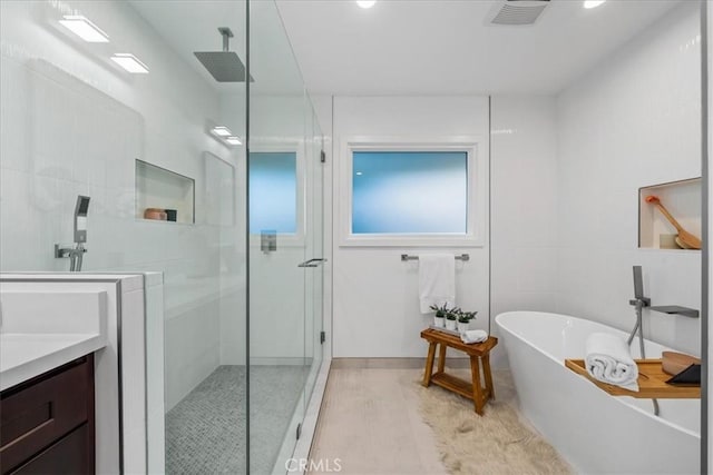 bathroom with vanity and separate shower and tub