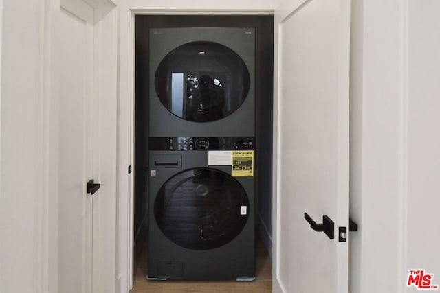 laundry area featuring stacked washer / dryer