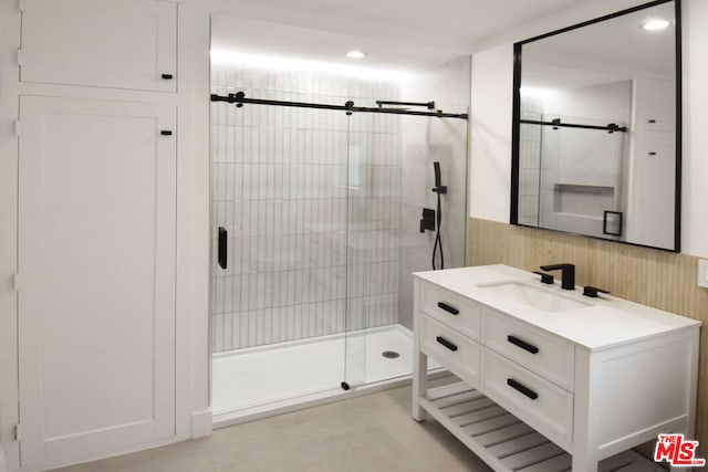 bathroom with walk in shower and vanity