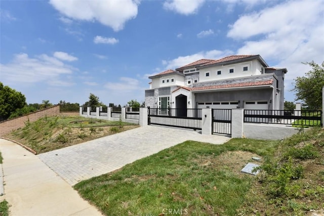 mediterranean / spanish-style home with a garage and a front yard