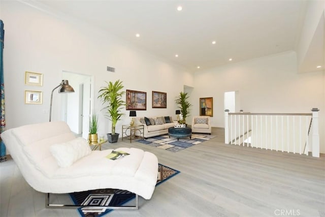 living room featuring crown molding and light wood-type flooring