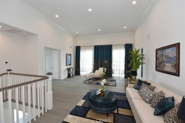 living room with ornamental molding and light hardwood / wood-style flooring