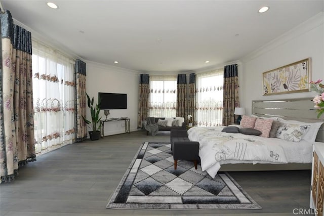 bedroom featuring crown molding, multiple windows, and hardwood / wood-style floors