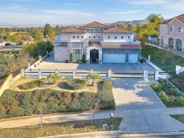 mediterranean / spanish house with a mountain view and a garage