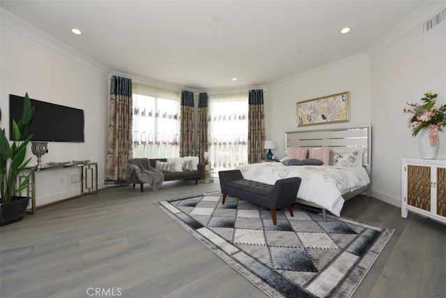 bedroom featuring ornamental molding and hardwood / wood-style floors