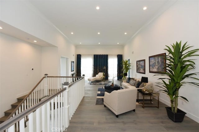 living room with wood-type flooring and crown molding