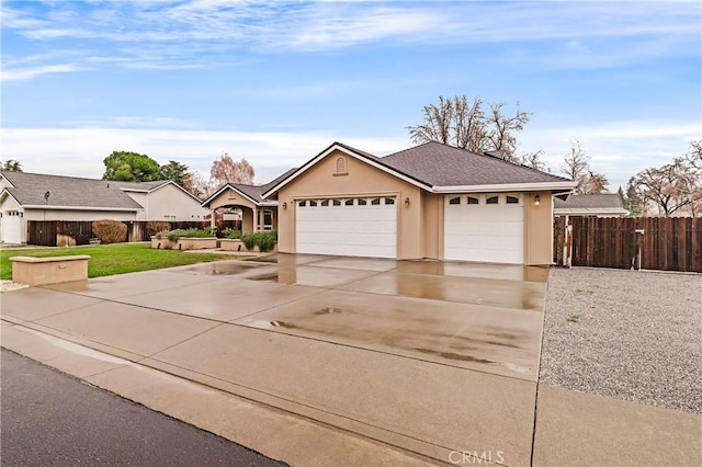 ranch-style house featuring a front lawn and a garage