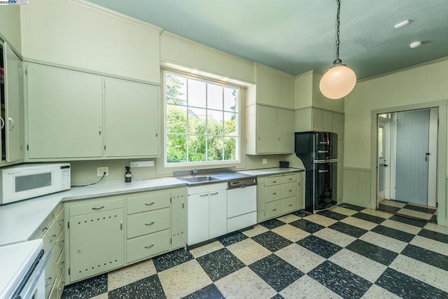 kitchen with decorative light fixtures, sink, white appliances, and white cabinets