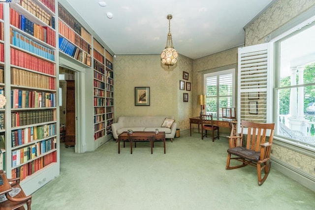 sitting room featuring carpet and ornamental molding