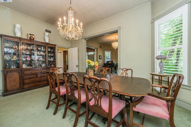 dining room featuring ornamental molding, light carpet, and an inviting chandelier